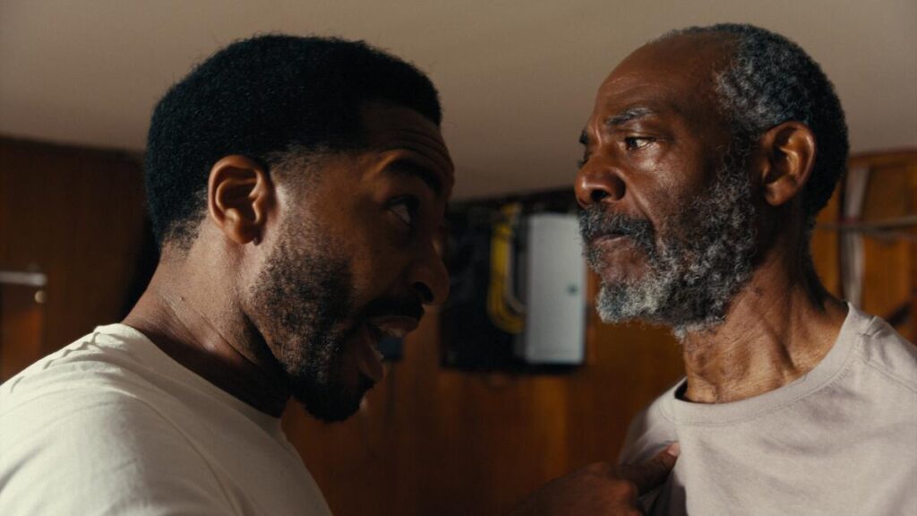 Two men in white t-shirts have a head-to-head showdown.