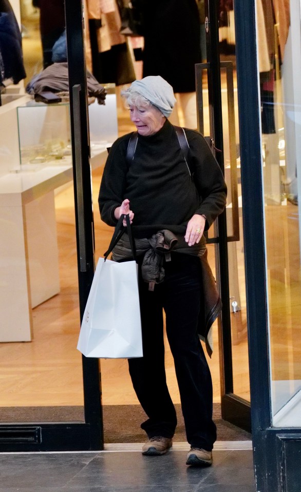 Dame Emma, wearing a light grey hat and dark jumper, laughed it off