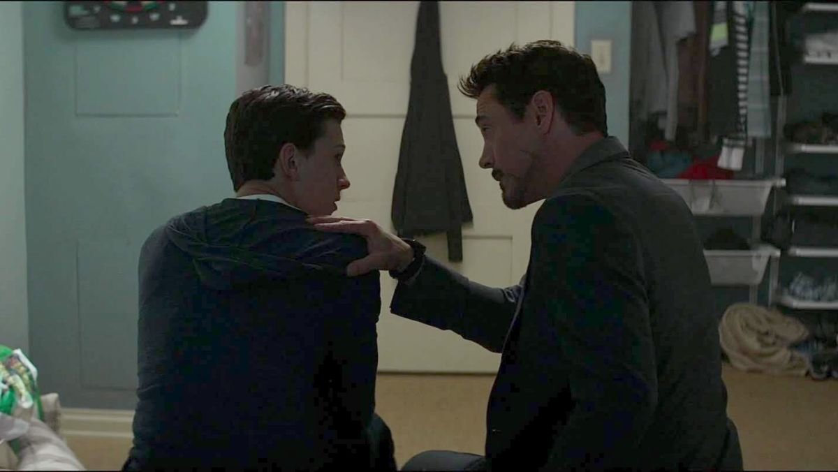 peter parker and tony stark sit on a bed in civil war movie