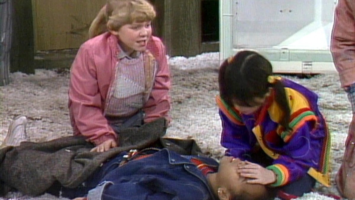 Two girls give CPR to a third outside on the ground on Punky Brewster