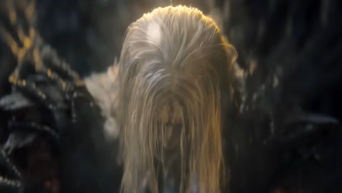 Knull with his head down hiding his face with his long white hair in Venom: The Last Dance