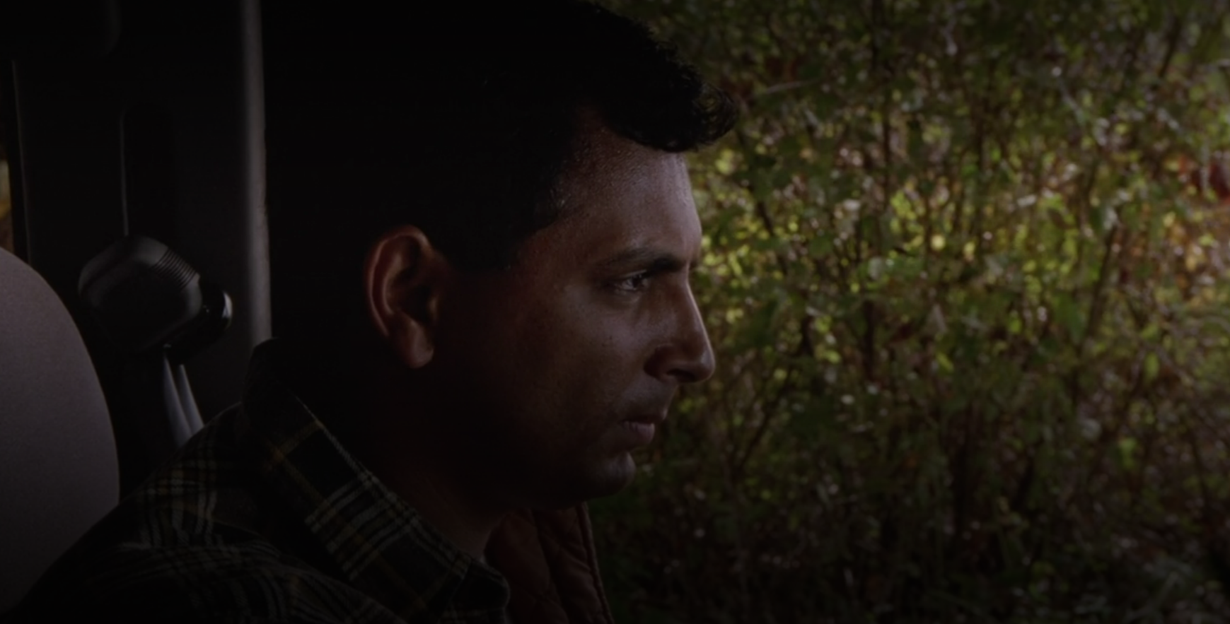 M. Night Shyamalan sitting in a truck in Signs 