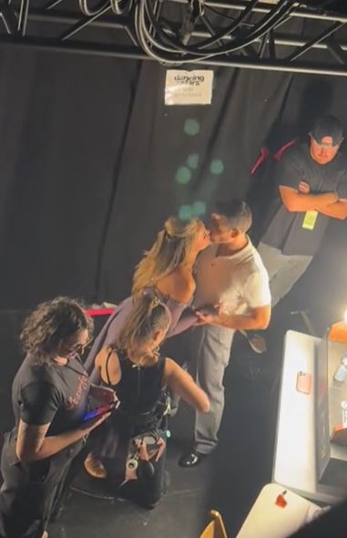 The couple was first spotted kissing when a backstage moment was caught on camera