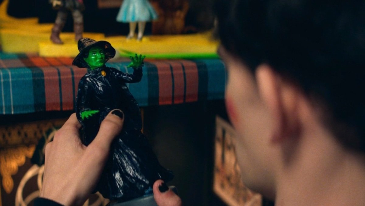 Billy holds a statue of the Wicked Witch of the West on Agatha All Along