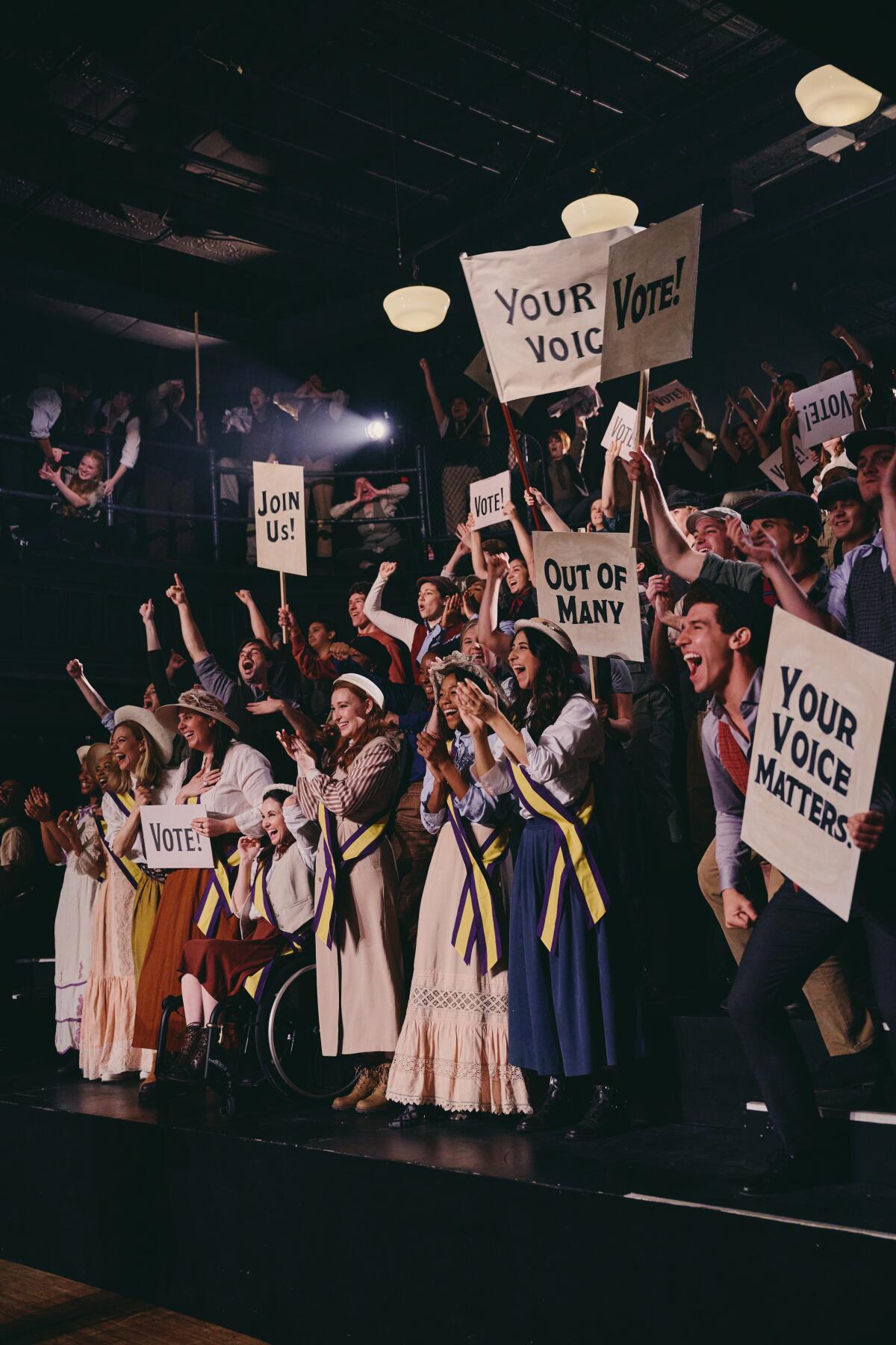 The company of Broadway Votes' "Newsies" music video holding signs encouraging voting.