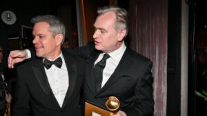 matt damon and christopher nolan embracing in tuxedos