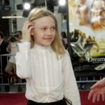 Dakota Fanning, seen here being ushered down the red carpet at the "Dreamer" premiere in 2005.