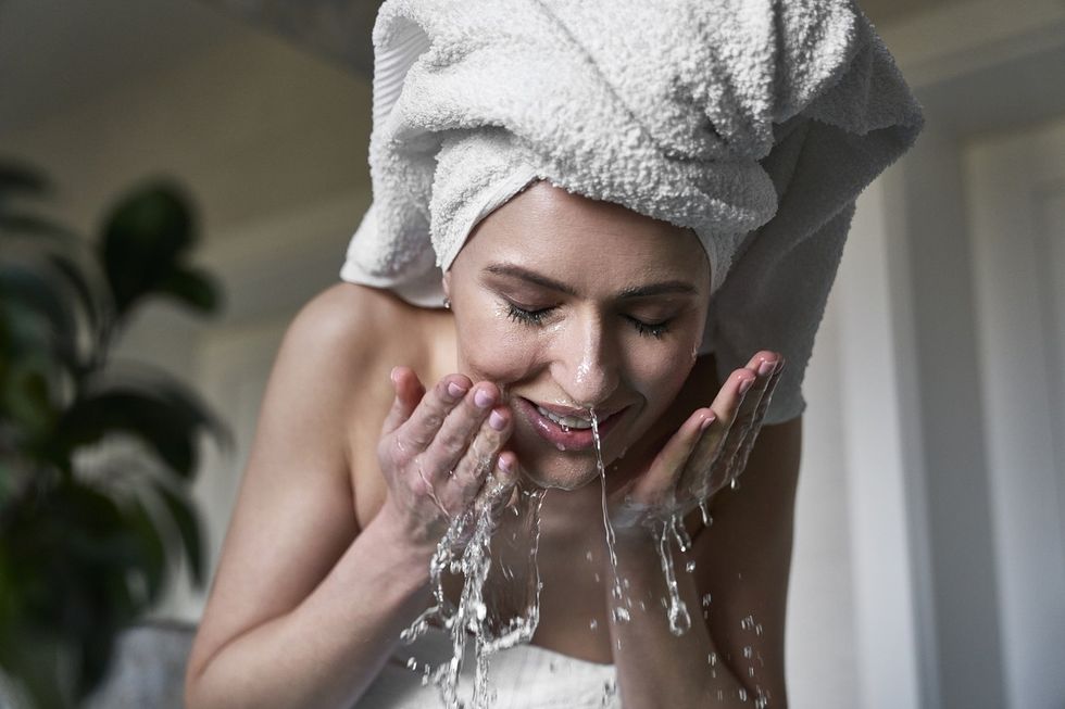 Woman washing face.