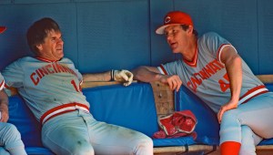 Pitching coach Jim Kaat (R) of the Cincinnati Reds talks to player/manager Pete Rose in the dugout during a Major League Baseball game against the Pittsburgh Pirates at Three Rivers Stadium in 1984 in Pittsburgh, Pennsylvania. 