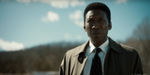 Mahershala Ali standing in an open field in True Detective season 3