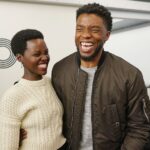 Nyong'o and Boseman in 2018 sharing a laugh at The Apollo Theater in New York City.