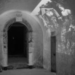 The entranceway, with a projection of old clowns, from the October 3, 2024 performance of Curios in the Catacombs by Margaret Leng Tan at Green-Wood Cemetery in New York