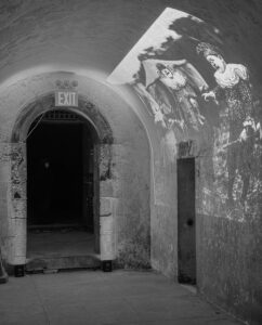 The entranceway, with a projection of old clowns, from the October 3, 2024 performance of Curios in the Catacombs by Margaret Leng Tan at Green-Wood Cemetery in New York