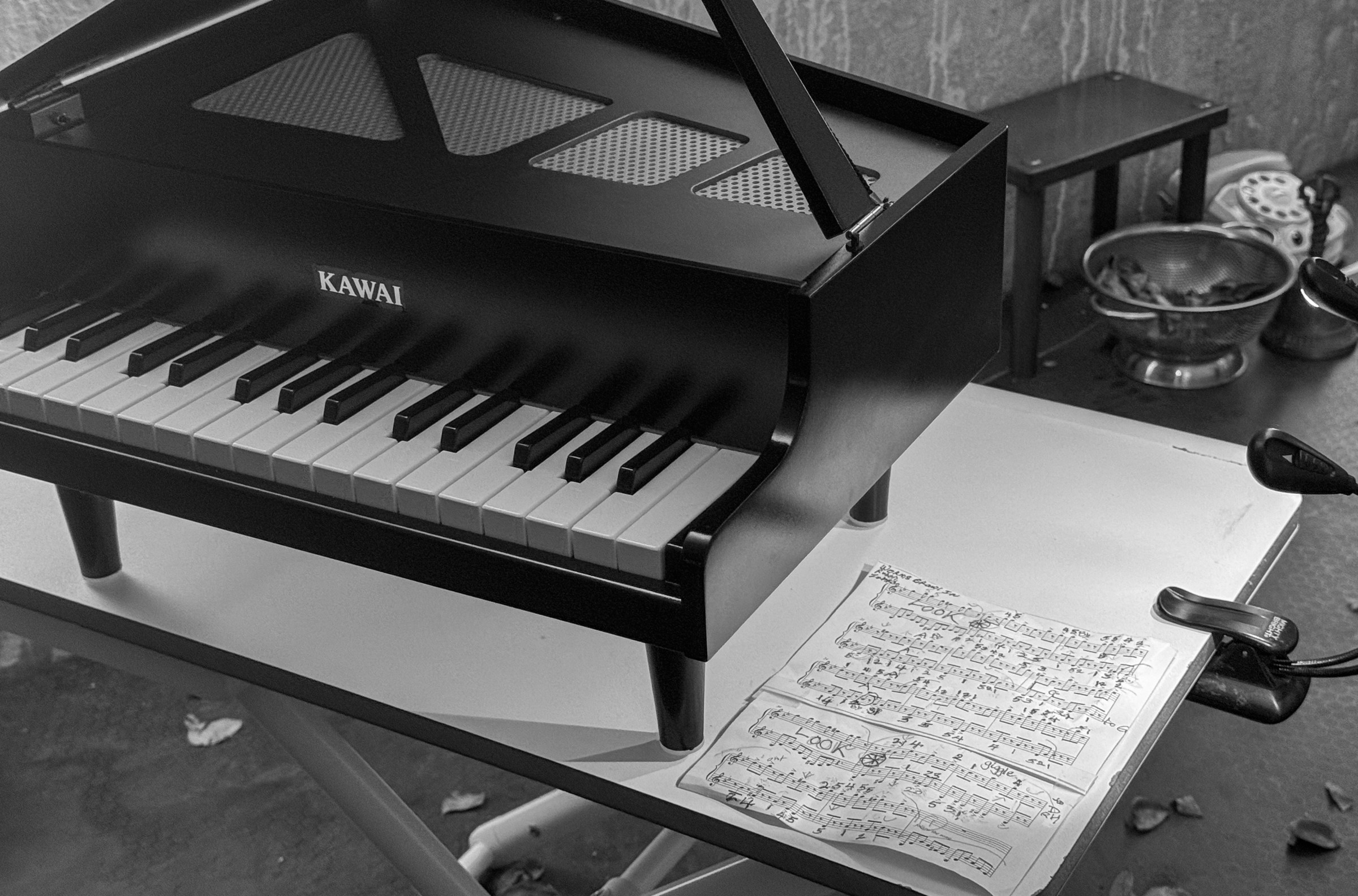 A toy piano and sheet music from the October 3, 2024 performance of Curios in the Catacombs by Margaret Leng Tan at Green-Wood Cemetery in New York