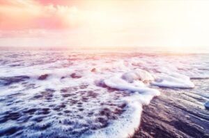 ocean waves on beach at sunrise