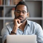 man questioning computer