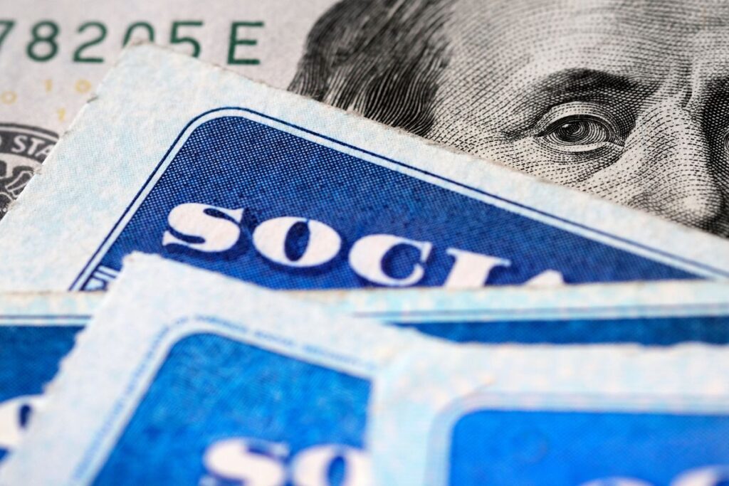 Several Social Security Cards on a US United States one hundred dollar bill