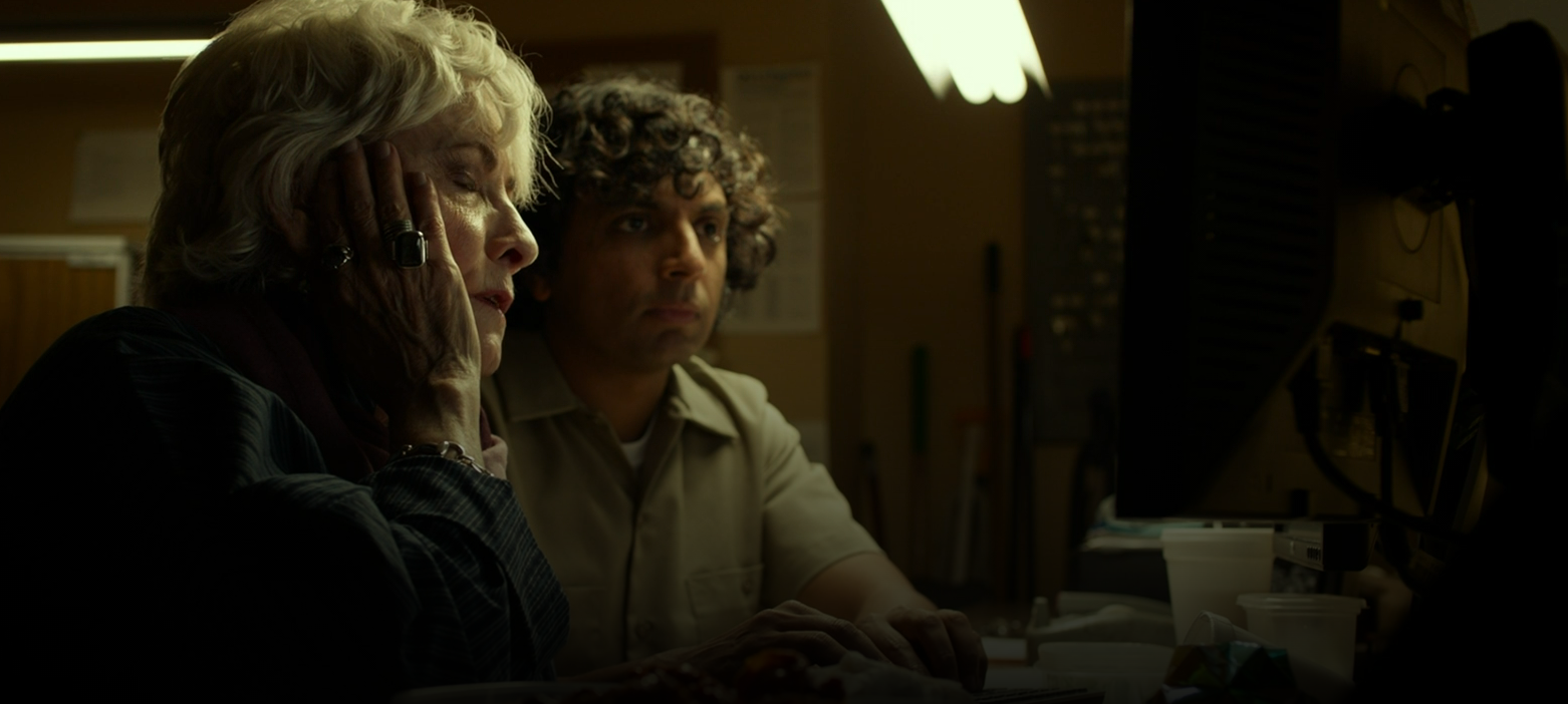 M. Night Shyamalan as Jai in Split, looking at a computer with an older woman 