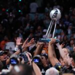 New York Liberty players hoist the WNBA Championship Trophy after winning Game Five of the WNBA Finals at Barclays Center on October 20, 2024 in New York City. (Photo by Elsa/Getty Images)