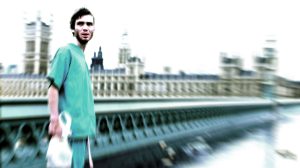 Cillian Murphy stands on a deserted London bridge in a blurry still from '28 Days Later'.