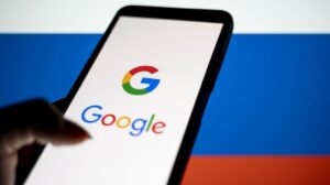 Google logo on phone in front of Russian flag