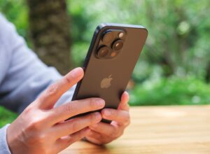 A man holds an iPhone 15 Pro