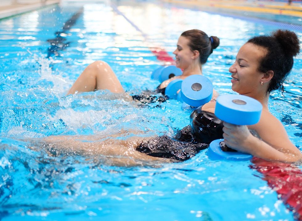 Two women doing aqua aerobics in a pool