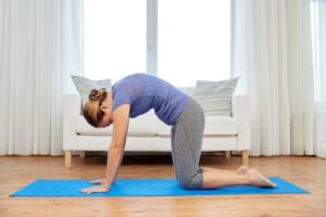 woman doing cat cow stretch