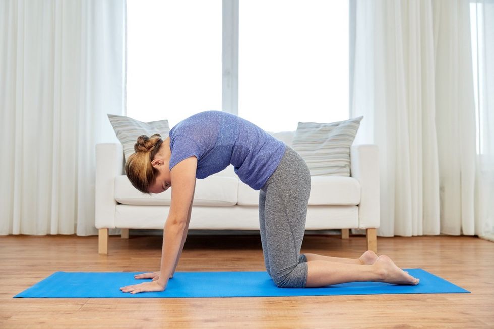 woman doing cat cow stretch