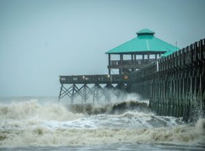 Hurricane storm surge kicks up the waves at Folly Beach pier near Charleston, S.C.