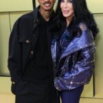 Alexander Edwards and Cher at the Versace Fall/Winter 2023 Fashion Show on March 9, 2023, in Los Angeles, California