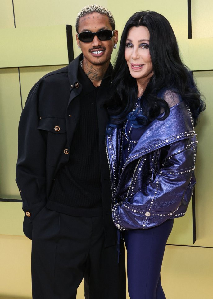 Alexander Edwards and Cher at the Versace Fall/Winter 2023 Fashion Show on March 9, 2023, in Los Angeles, California