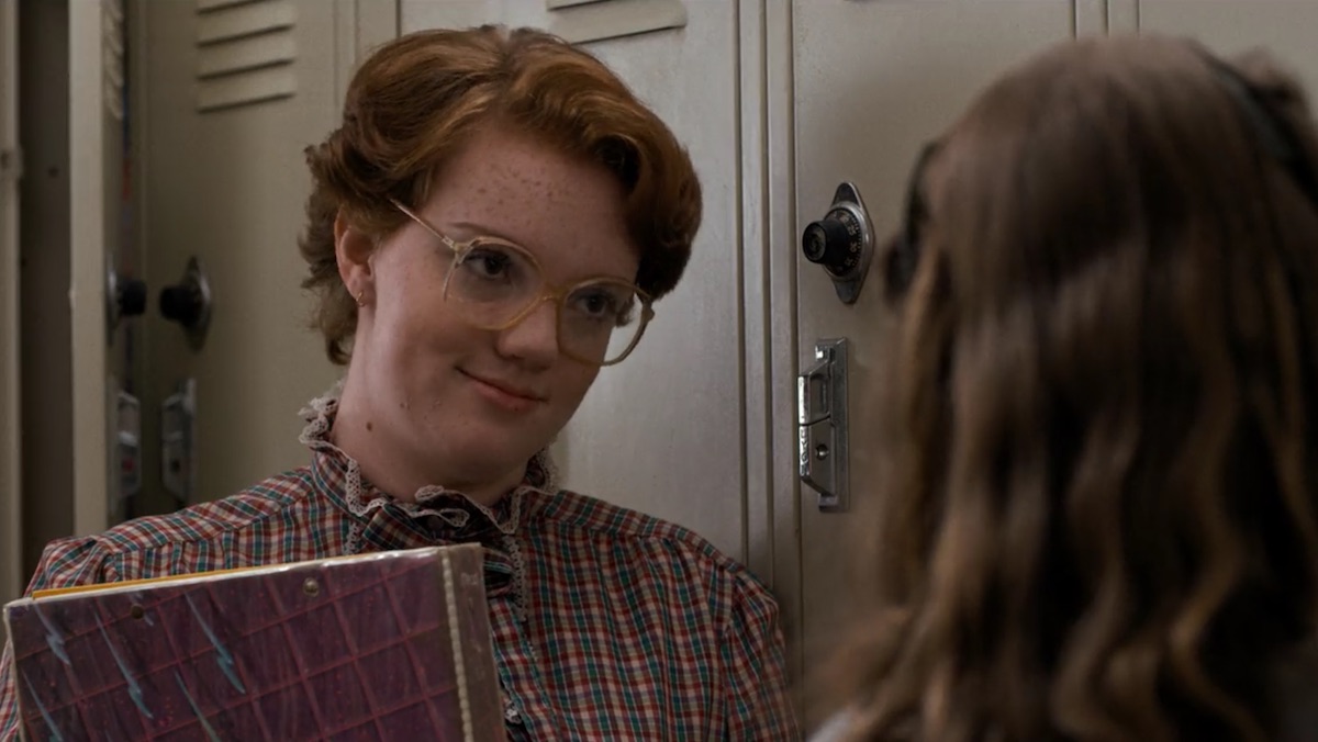 barn with her glasses and books near lockers on Stranger Things