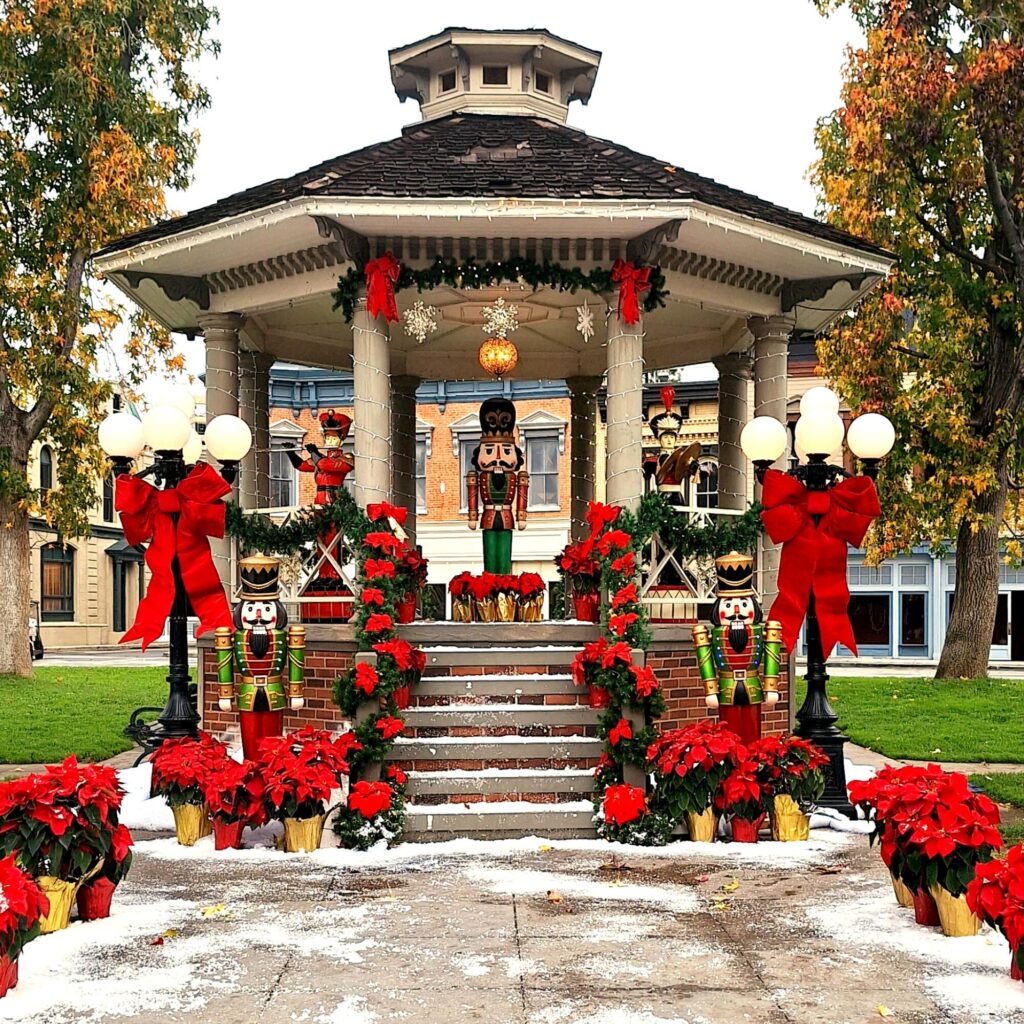 A backlot gazebo with a large nutcracker figurine in its center.