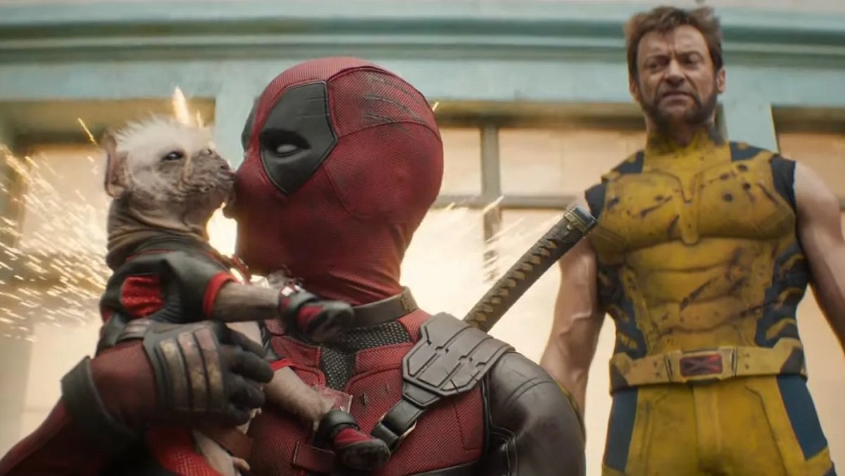 Deadpool smooches Dogpool while Wolverine looks annouyed