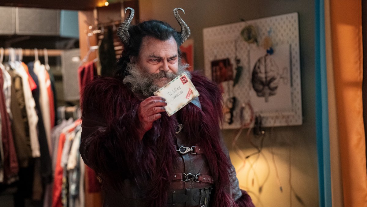 Jack Black as Satan holding a letter in a child's bedroom