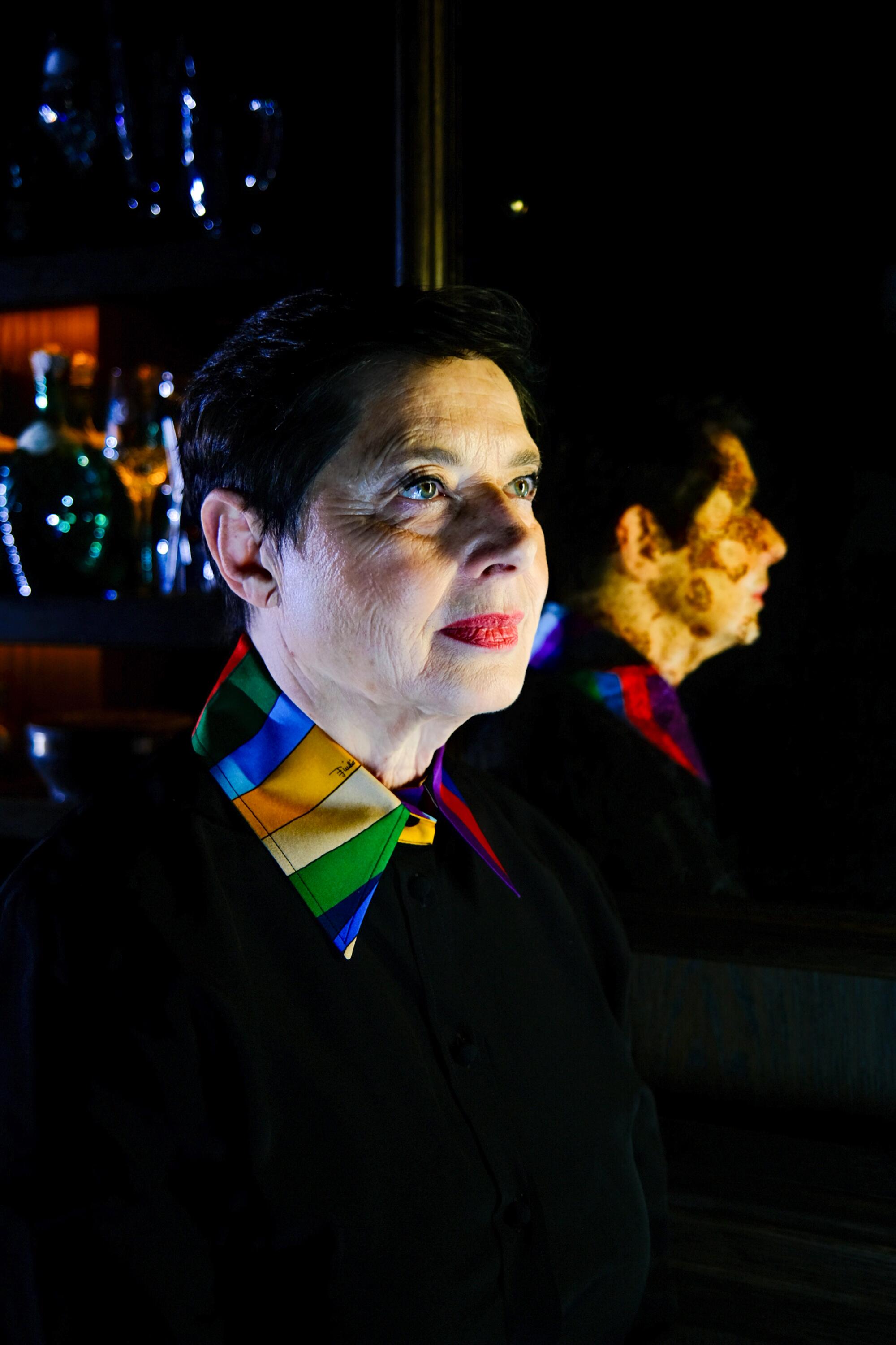 Isabella Rossellini in profile in front of a mirror