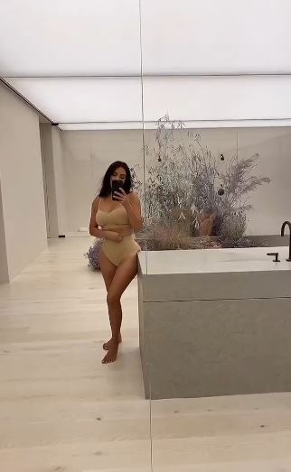 Kim pictured in the eight-bedroom minimalist house