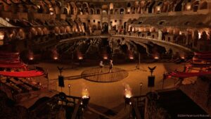 Two gladiators in the middle of the Colosseum,  ready to fight.