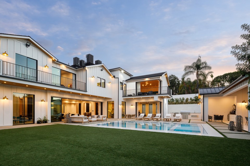 A cabana, BBQ pit and lounge area surround the backyard's pool