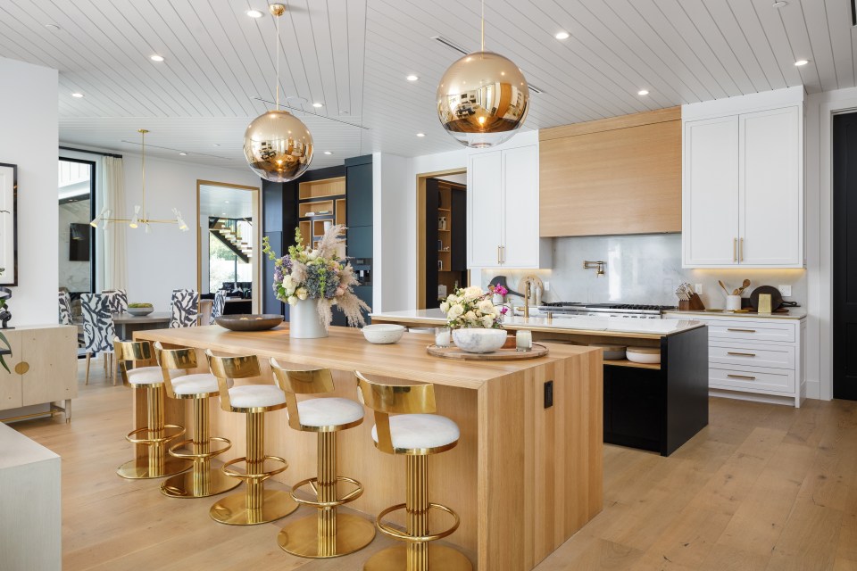 The massive kitchen has two floating islands and gold hardware