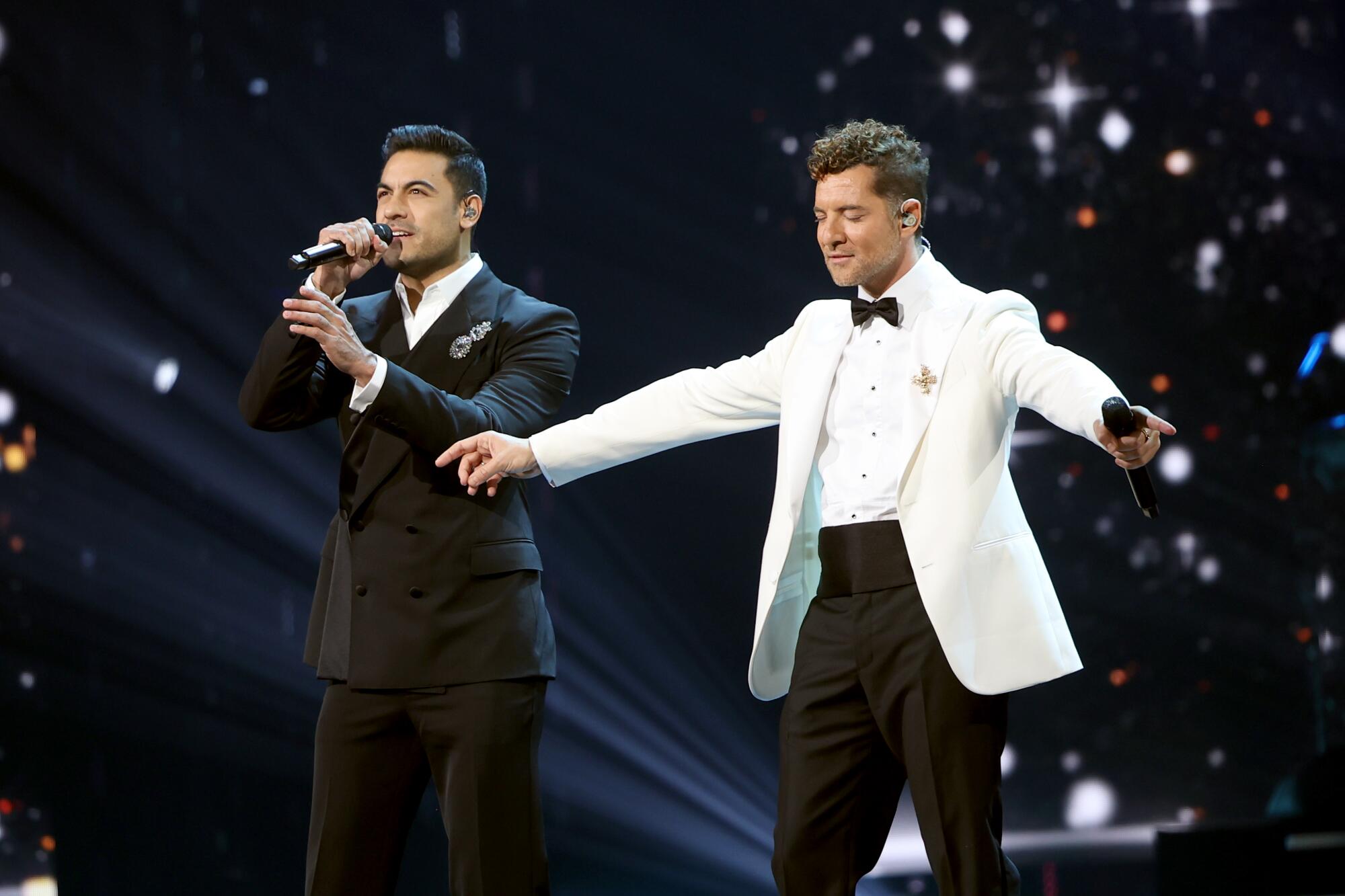 Carlos Rivera and David Bisbal perform onstage 