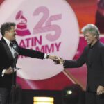 Carlos Vives and Jon Bon Jovi smile after Vives received the Person of the Year award at the 25th Latin Grammy Awards