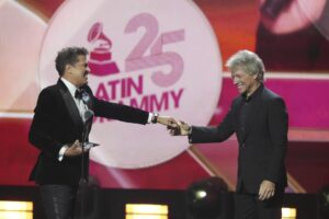 Carlos Vives and Jon Bon Jovi smile after Vives received the Person of the Year award at the 25th Latin Grammy Awards