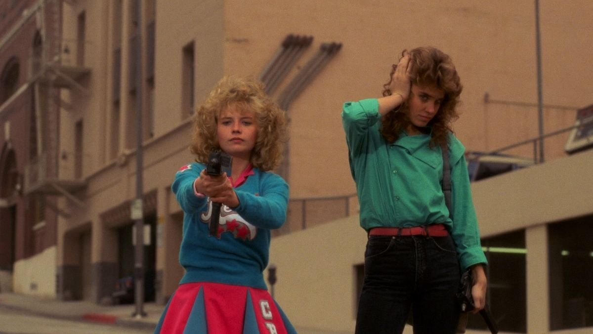 image of two girls standing in the streets int he 80s with weapons in  night of the comet