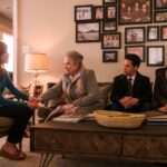 An older woman shakes hands with a younger women as two others join her on the couch in a scene from "Matlock."