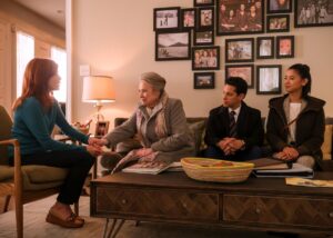 An older woman shakes hands with a younger women as two others join her on the couch in a scene from "Matlock."