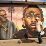 A defaced mural of Kendrick Lamar