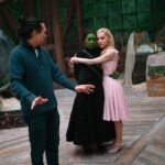 Director Jon M. Chu with Cynthia Erivo and Ariana Grande on the set of "Wicked."