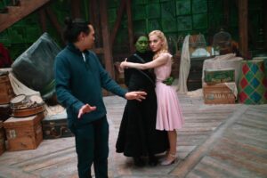 Director Jon M. Chu with Cynthia Erivo and Ariana Grande on the set of "Wicked."